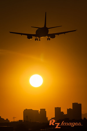 Airliner descending into Sky Harbor Airport at Sunset.